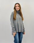 Maglione collo alto con frange