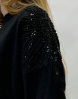 Maglione con dettagli gioiello sulle spalle
