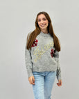 Maglione con scritta believe e fiocchi di neve