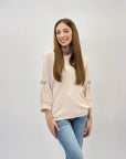 Maglia con maniche a sbuffo con gioielli