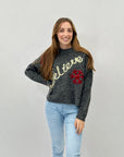 Maglione con scritta believe e fiocchi di neve