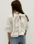 Blusa over con fiocco posteriore e manica ampia
