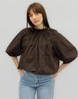 Blusa over con fiocco posteriore e manica ampia
