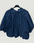 Blusa over con fiocco posteriore e manica ampia