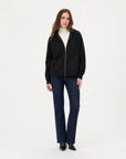 Cardigan donna in maglia con cappuccio e zip nero indossato da Polly 2 - figura intera