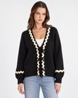 Cardigan donna con fiocchi e bordi ondulati Nero, Polly 2 — vista frontale