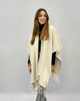 Poncho morbido tinta unita con frange