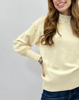 Maglione lupetto con dettagli frange
