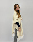 Poncho morbido tinta unita con frange