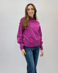 Maglione lupetto con dettagli frange