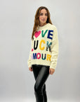 Maglione oversize con scritta love luck amor