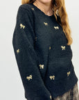Maglione morbido con fiocchi in paillettes