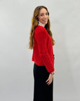 Pullover con chiusura a spilla con perla