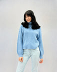 Maglione dolcevita con intrecci