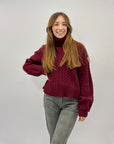 Maglione dolcevita con intrecci