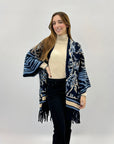 Poncho caldo con fantasia e frange