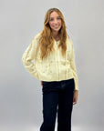 Maglia con zip e cappuccio con borchie