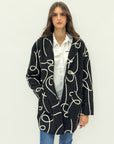 Cappotto in bouclé con fantasia grafica