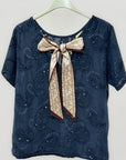Blusa ricamata con fiocco sul retro elegante e raffinata