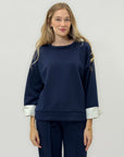 Completo in tessuto tecnico con felpa oversize e pantalone palazzo