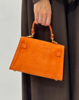 Mini bag a mano in vera pelle scamosciata con chiusura gioiello