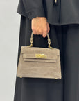Mini bag a mano in vera pelle scamosciata con chiusura gioiello