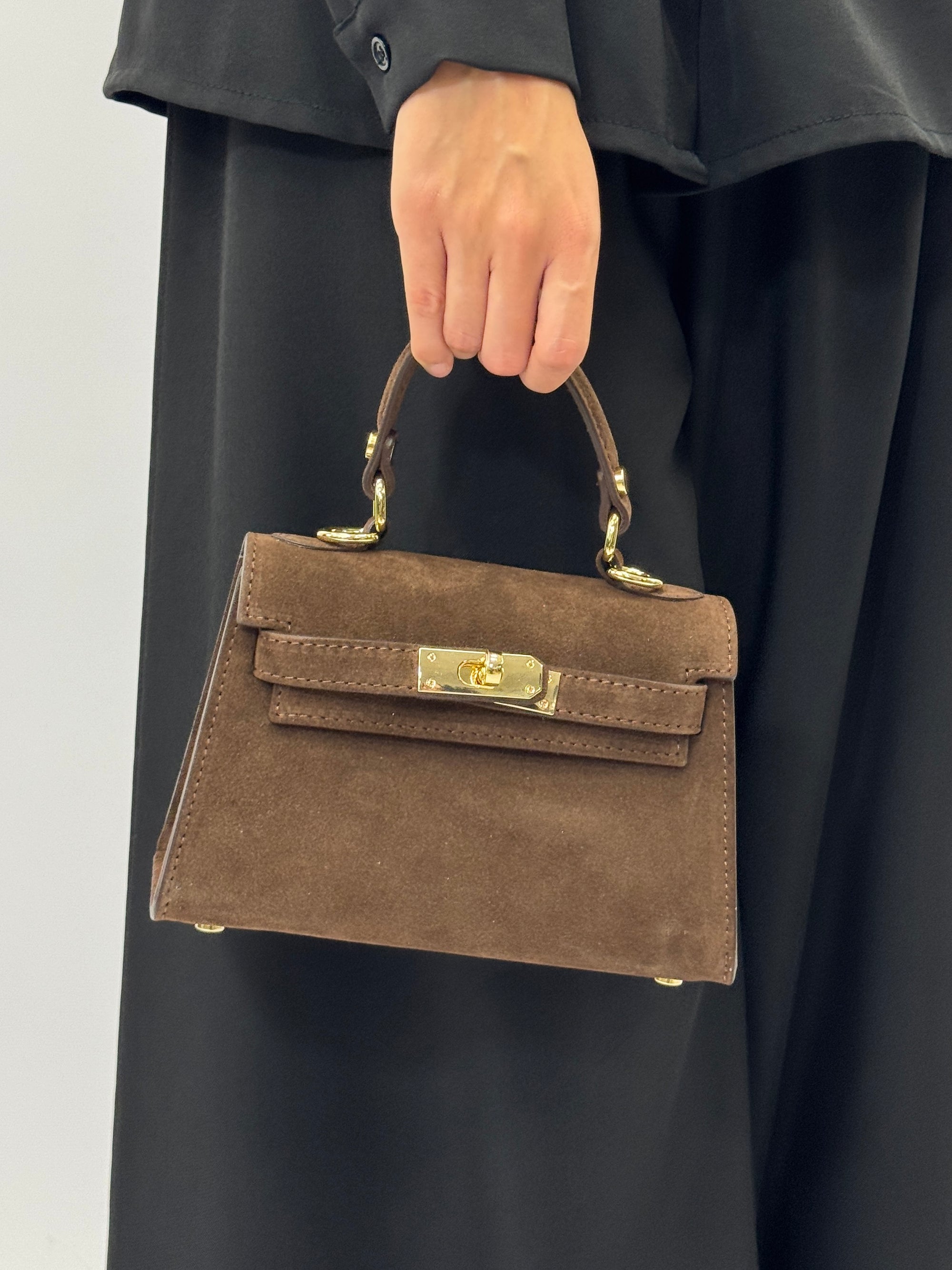 Mini bag a mano in vera pelle scamosciata con chiusura gioiello