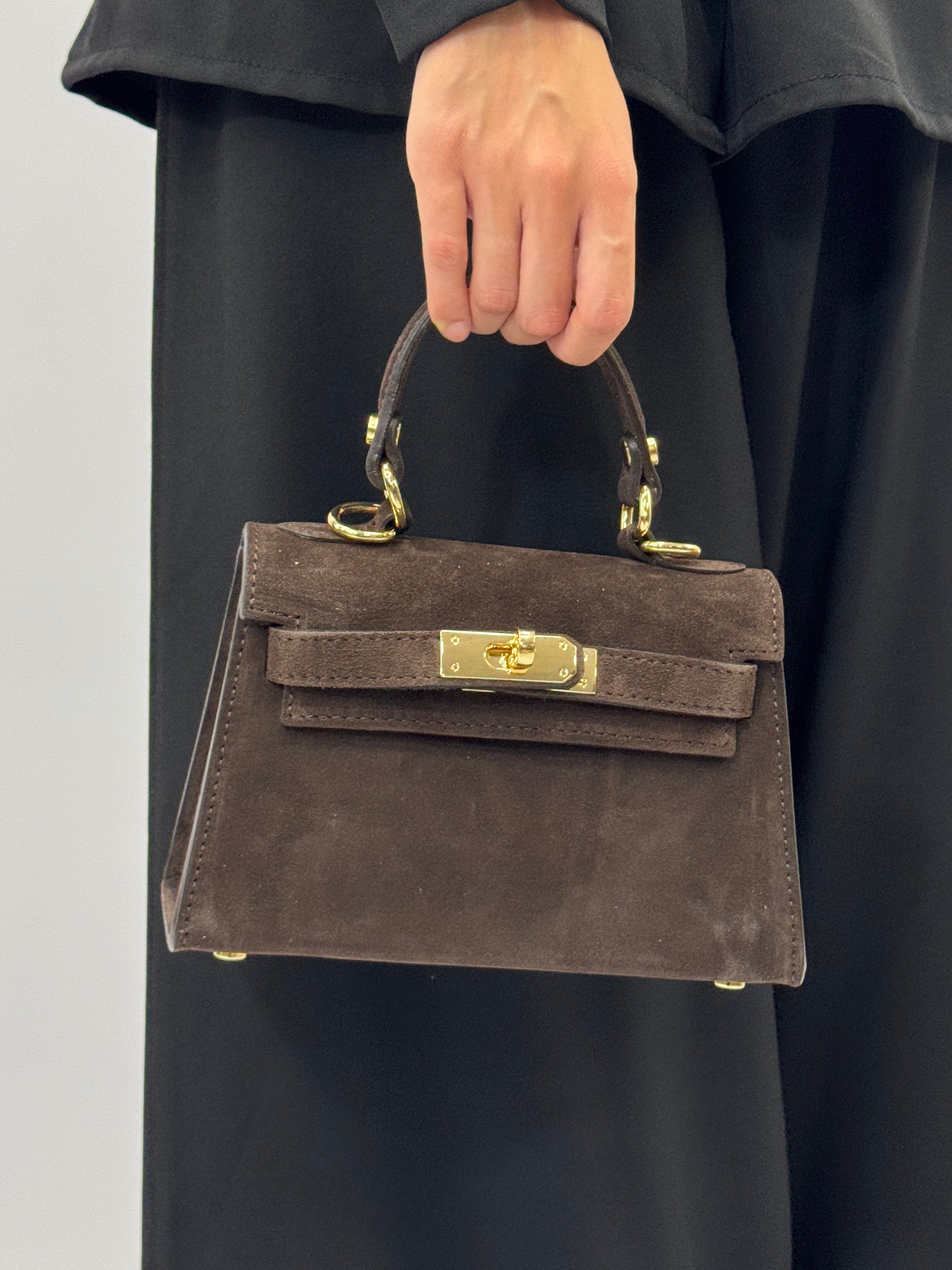 Mini bag a mano in vera pelle scamosciata con chiusura gioiello