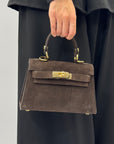 Mini bag a mano in vera pelle scamosciata con chiusura gioiello