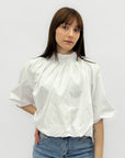Blusa over con fiocco posteriore e manica ampia