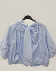 Blusa over con fiocco posteriore e manica ampia