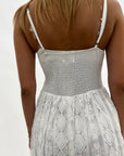 Abito con spalline in pizzo sangallo asimmetrico