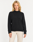 Maglia donna collo alto nero con bottoni sui polsini indossata da Polly 7, vista frontale