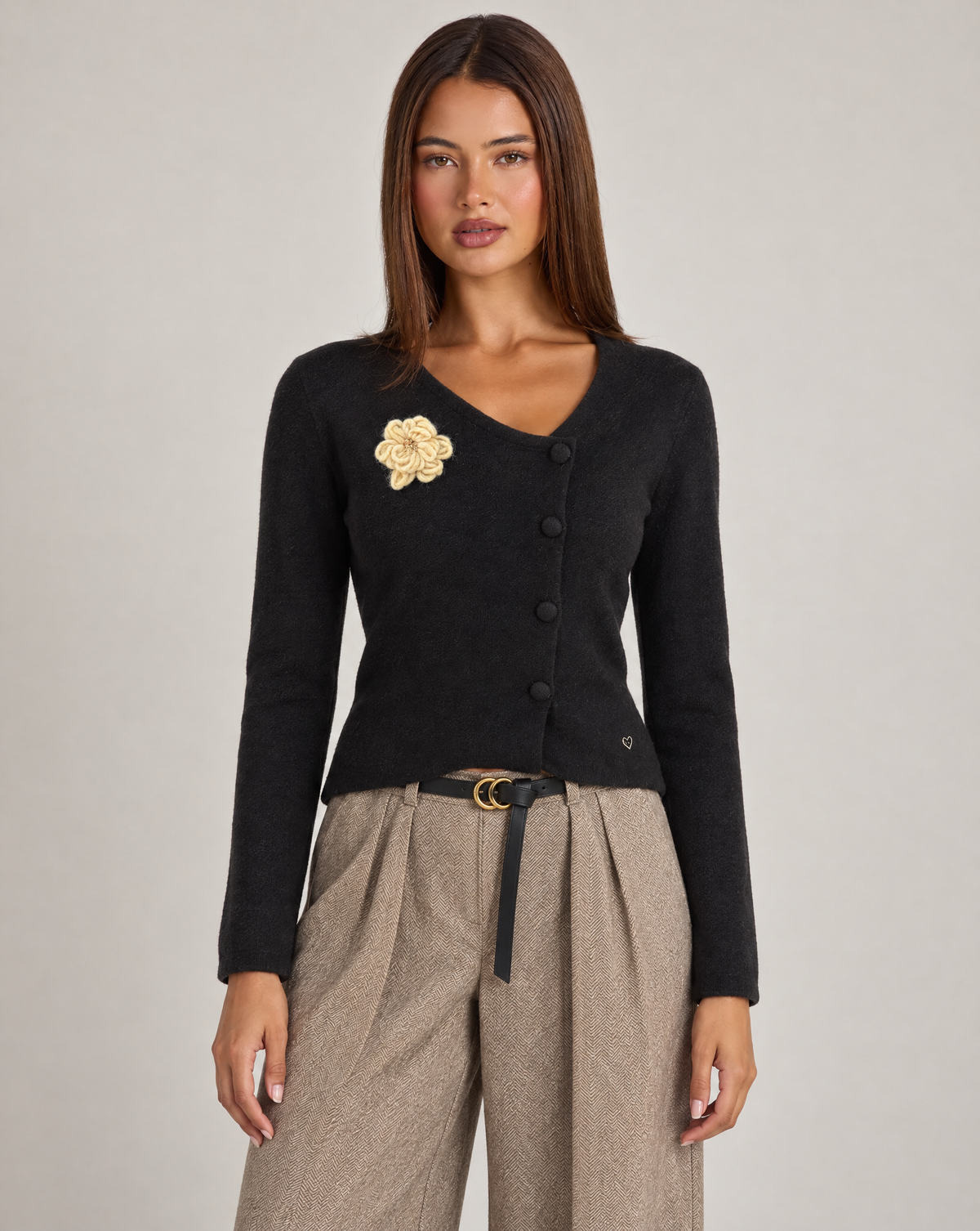 Cardigan donna nero con fiore e bottoni asimmetrici, indossato da Polly 4 con pantaloni spigati – vista frontale