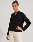 Cardigan donna corto nero con collo alto, bottoni e tasche, indossato da Polly 6 – tre-quarti