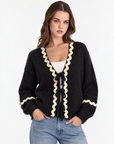 Cardigan donna con fiocchi e bordi ondulati Nero, Polly 2 — dettaglio parte superiore
