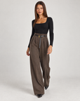 Pantaloni donna a palazzo spigati marrone con cintura, indossati da Polly 4 – vista tre quarti